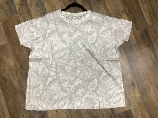 White oversized Ice Woodland camo tee laid flat on a wooden floor