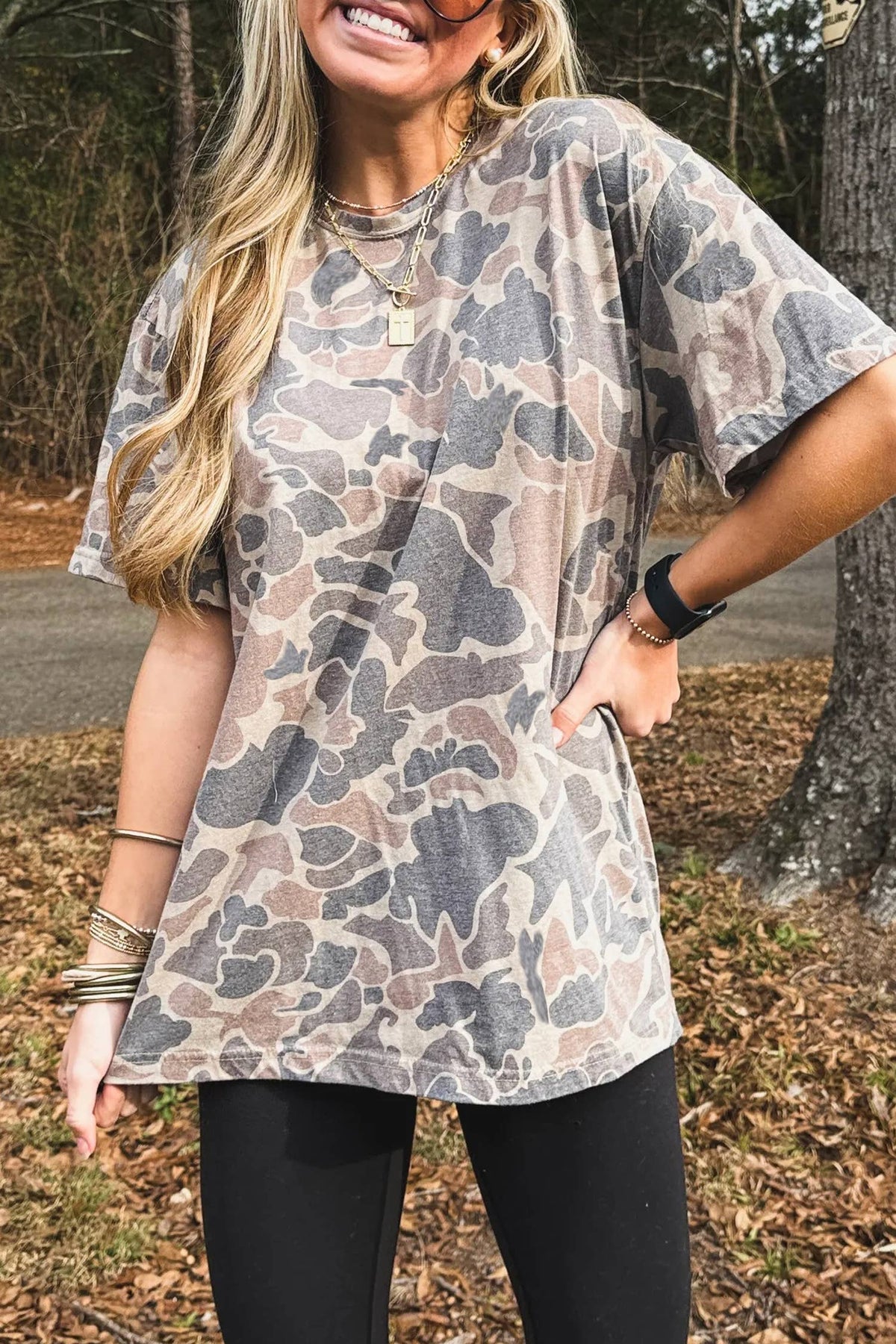 Woman wearing a camouflage tunic in an outdoor setting