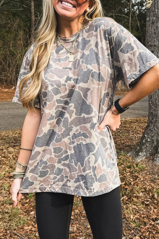 Woman wearing a camouflage tunic in an outdoor setting