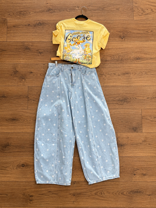 Light wash denim wide-leg barrel jeans with white polka dot print, high-rise waist, relaxed oversized fit, and cropped ankle-length hem with subtle tapered cuffs