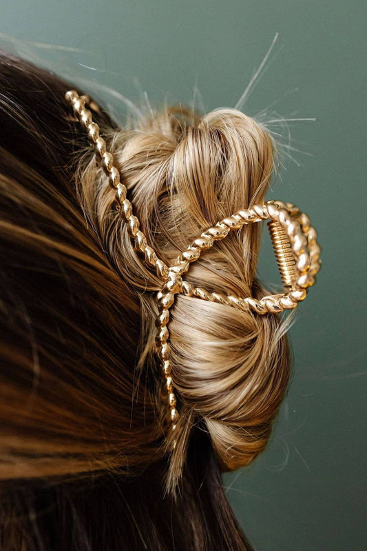 Gold hair accessory in a styled bun 